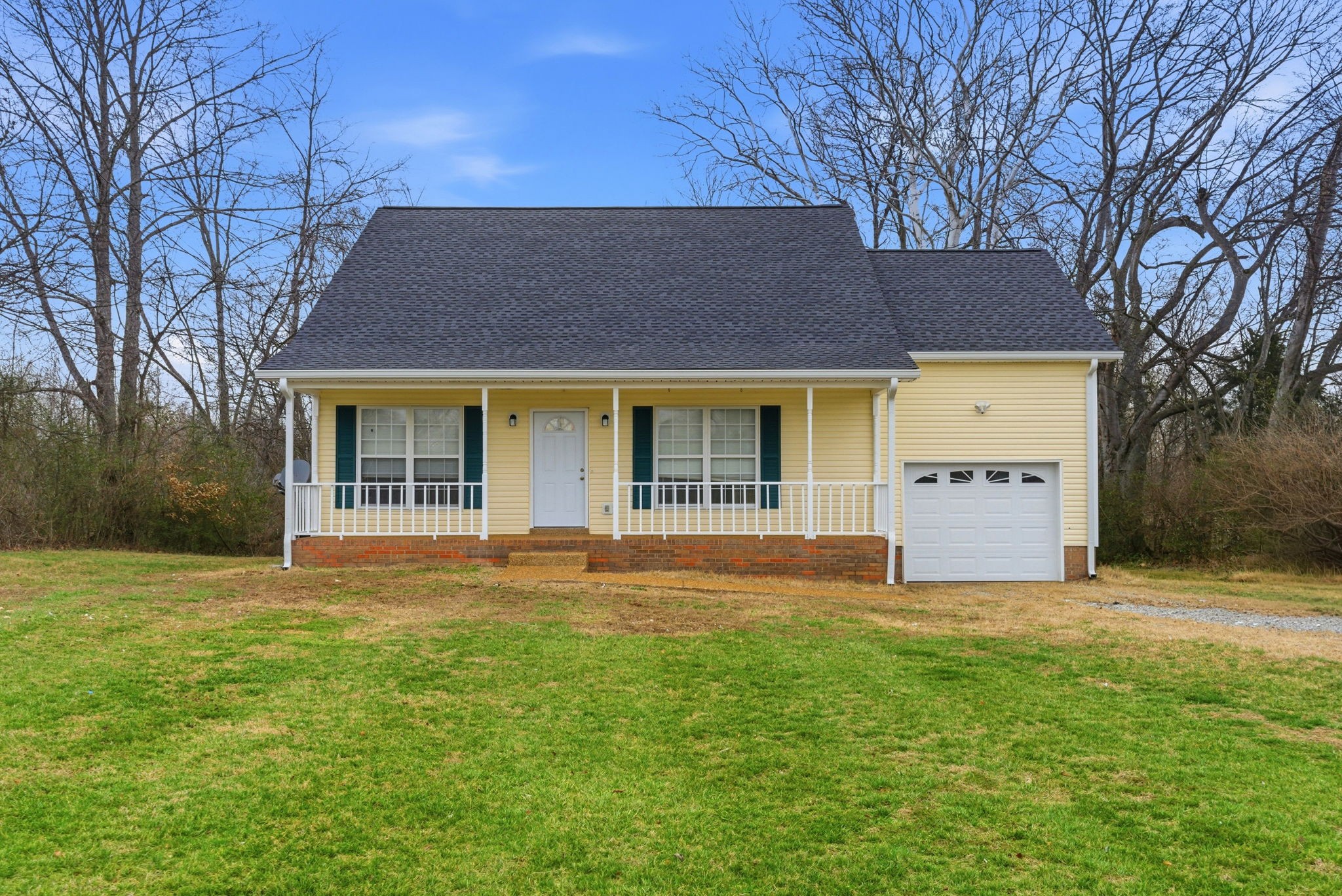 230 Woodruff Road Adams, TN 37010 - Photo 2 of 36 a front view of a house with a yard and a large tree