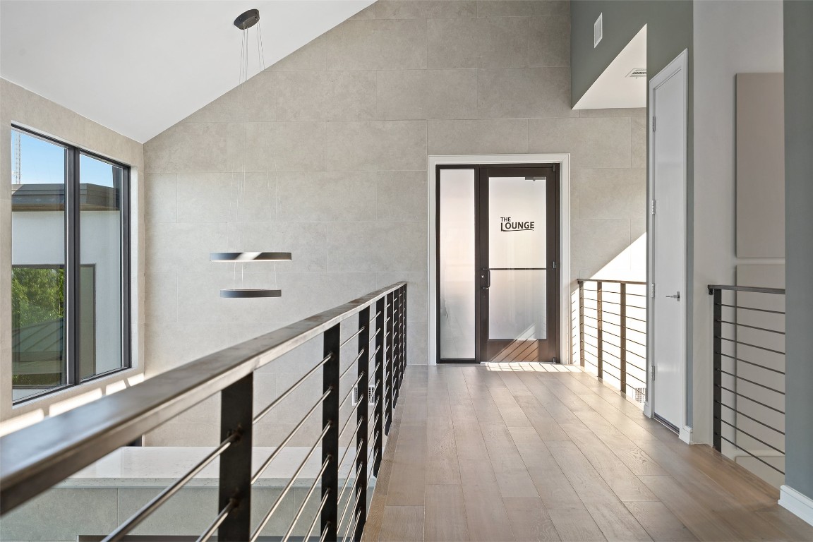 2551 Waymaker Way Austin, TX 78746 - Photo 17 of 36 a view of a hallway with wooden floor and staircase