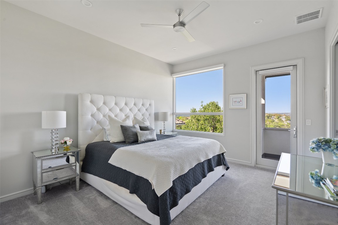2551 Waymaker Way Austin, TX 78746 - Photo 22 of 36 a bedroom with a bed potted plant on dresser and a window