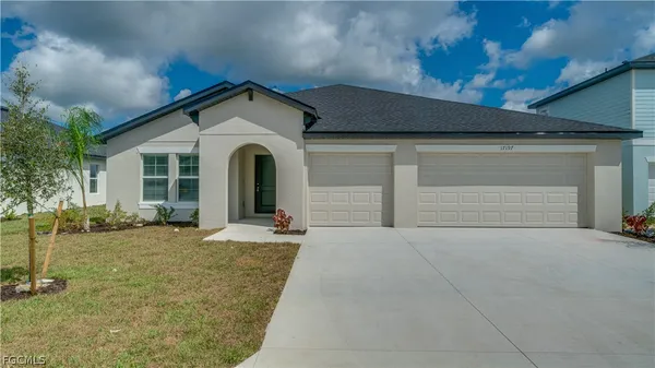 a view of a house with a yard and garage