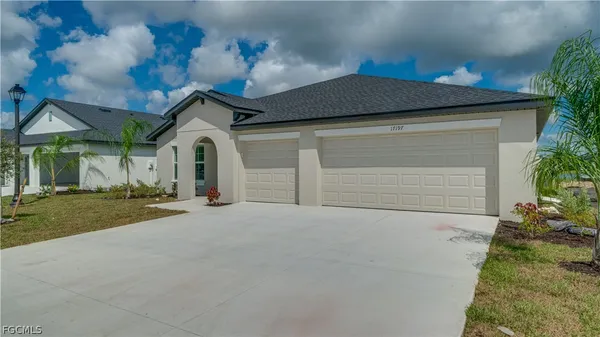 a front view of a house with a yard and garage
