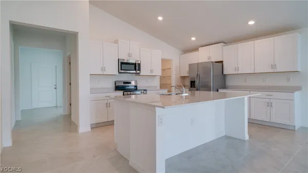 a kitchen with cabinets stainless steel appliances and a counter top space