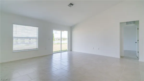 an empty room with a empty space and windows