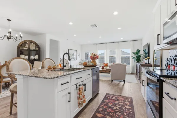 a living room with furniture and wooden floor