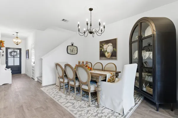 a living room with furniture a flat screen tv and a large window