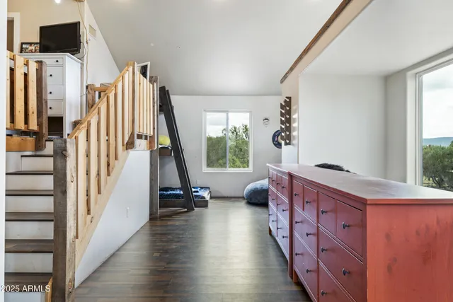 a view of a livingroom with furniture window and wooden floor
