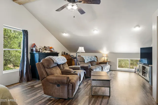 a bedroom with a bed a window and a potted plant