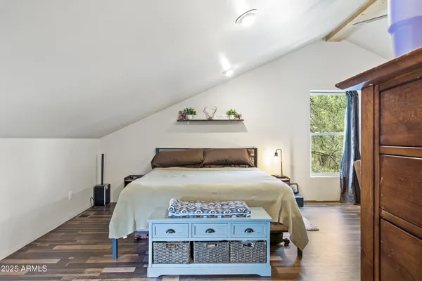 a bed room with a bed and a television