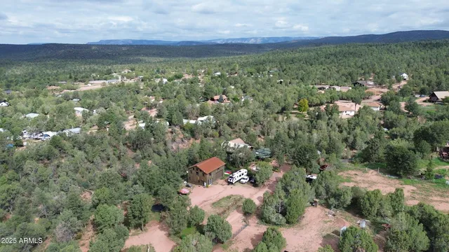 an aerial view of multiple houses with yard