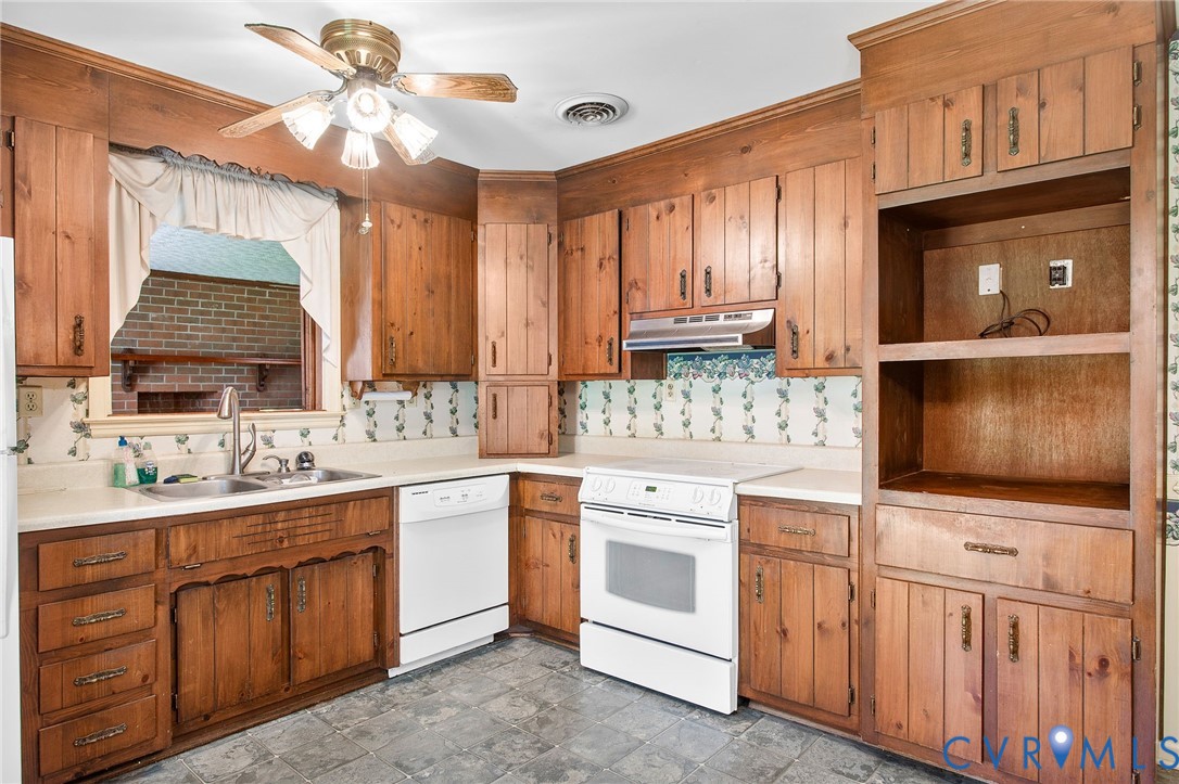 3513 Union Branch Road Petersburg, VA 23805 - Photo 14 of 32 a kitchen with a sink stove and cabinets