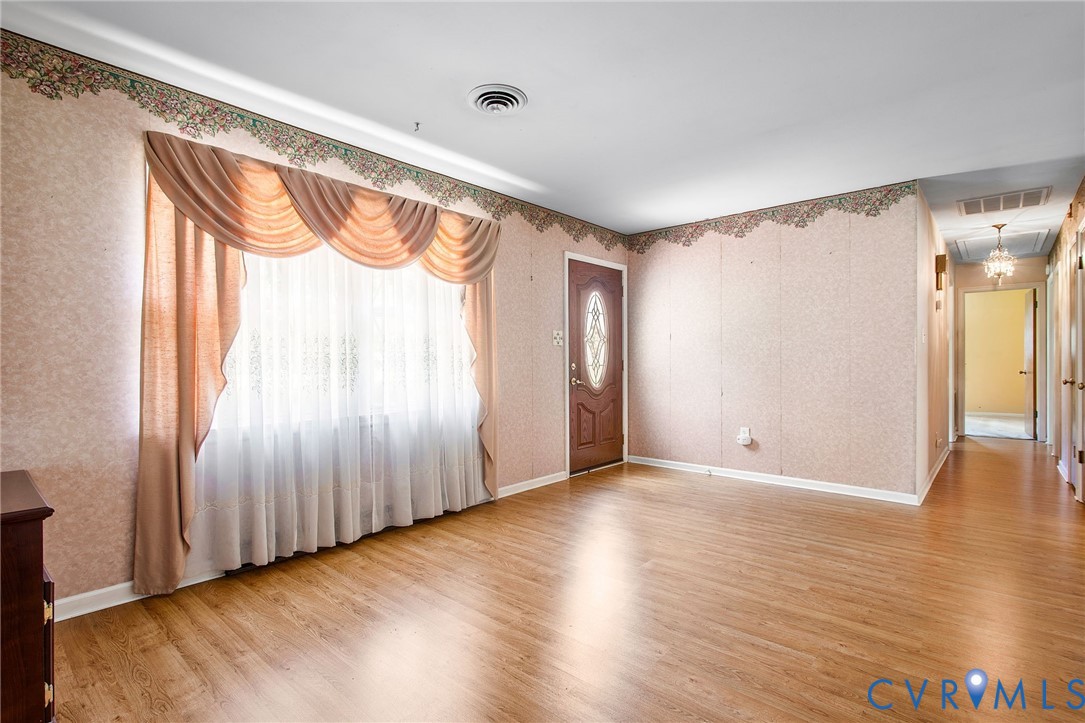 3513 Union Branch Road Petersburg, VA 23805 - Photo 6 of 32 a view of an empty room with wooden floor and a window