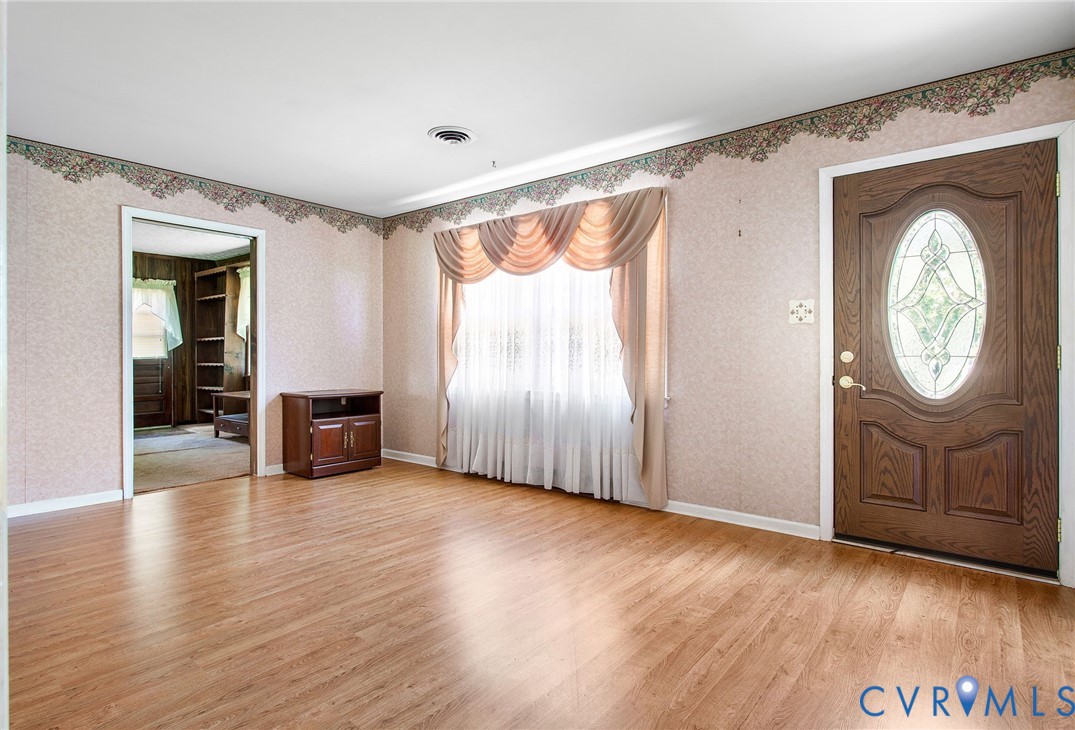 3513 Union Branch Road Petersburg, VA 23805 - Photo 7 of 32 a view of an empty room with a window and wooden floor