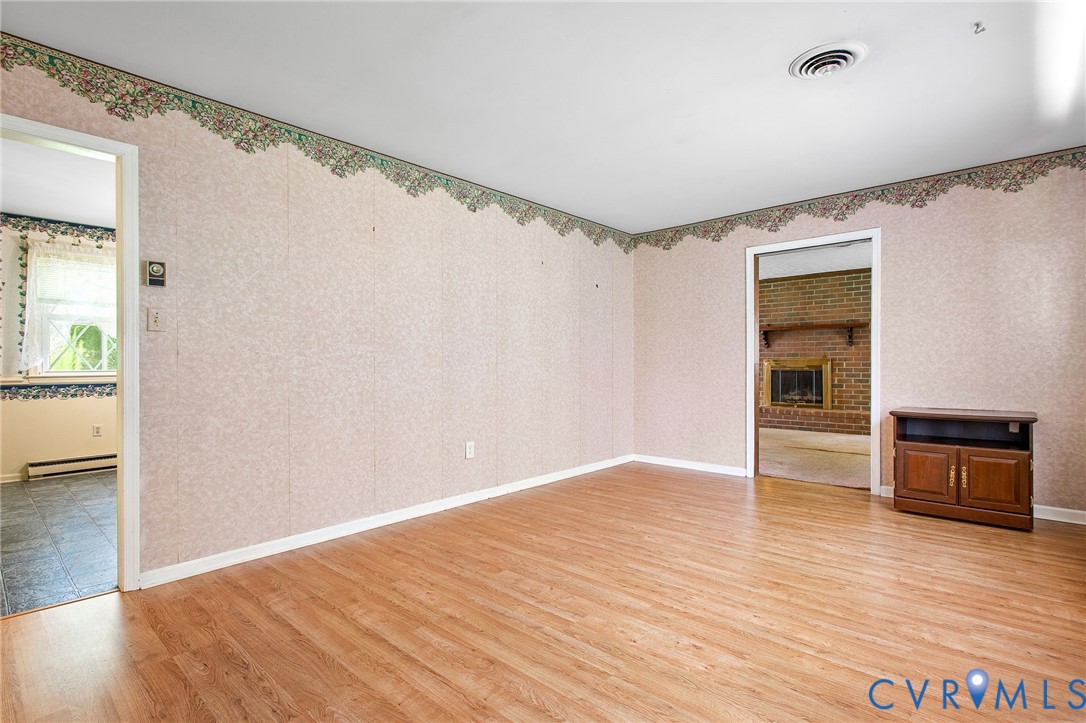 3513 Union Branch Road Petersburg, VA 23805 - Photo 8 of 32 a view of an empty room with wooden floor and a window