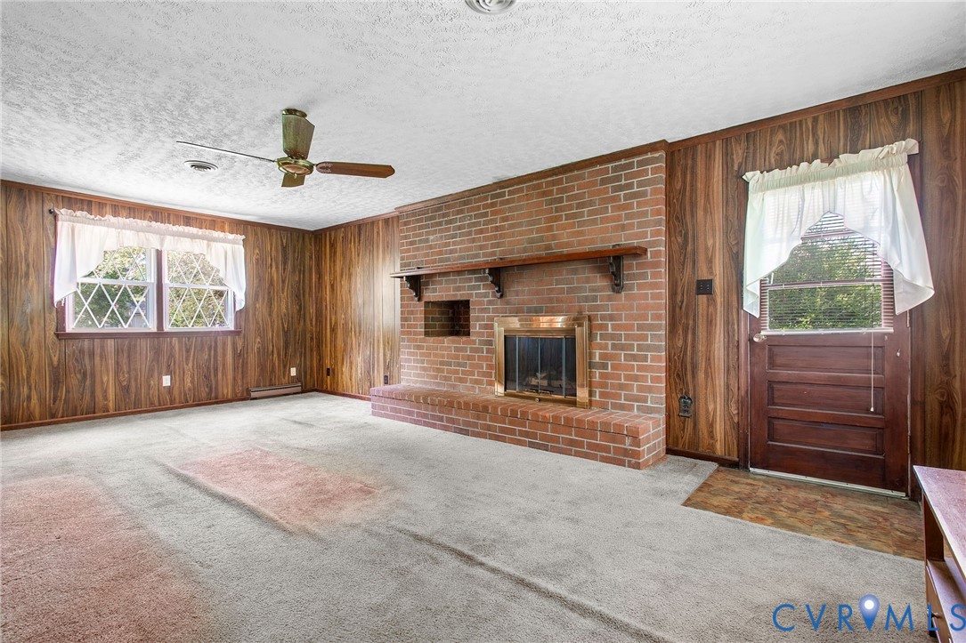 3513 Union Branch Road Petersburg, VA 23805 - Photo 9 of 32 a view of an empty room with a fireplace and a window