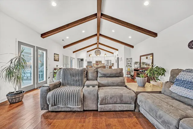 a dining room with furniture and wooden floor