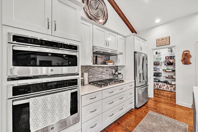 a living room with furniture and flat screen tv