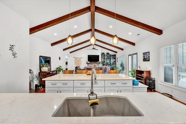 a bedroom with a bed and a large mirror on the dresser