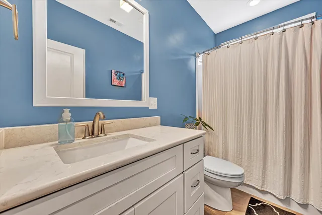 a spacious bedroom with a bed couch and a large window