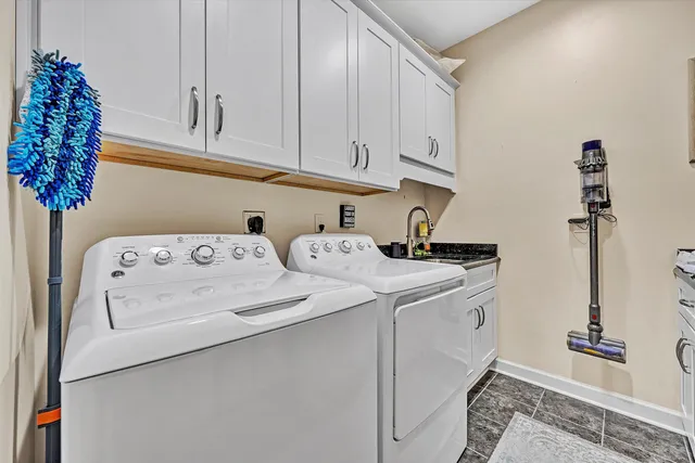 a view of a patio with table and chairs near a barbeque