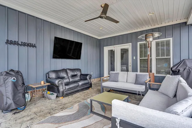 a view of a house with wooden deck and furniture