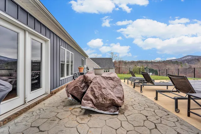 a view of a house with backyard porch and sitting area