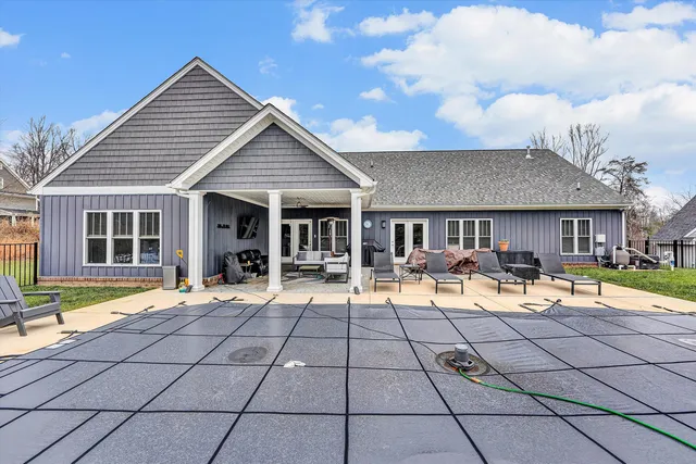 a view of a house with backyard and sitting area