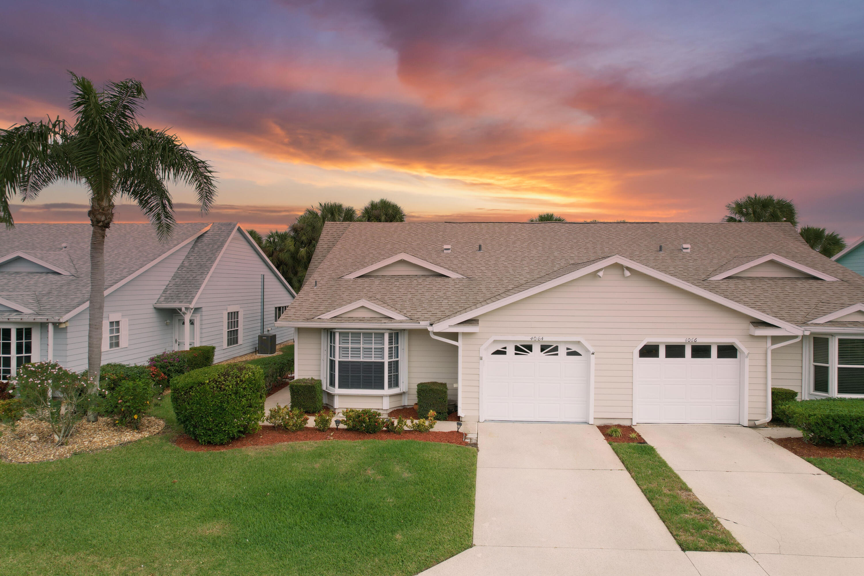 4064 Gator Trace Road Fort Pierce, FL 34982 - Photo 1 of 37 a view of a white house with a big yard and potted plants