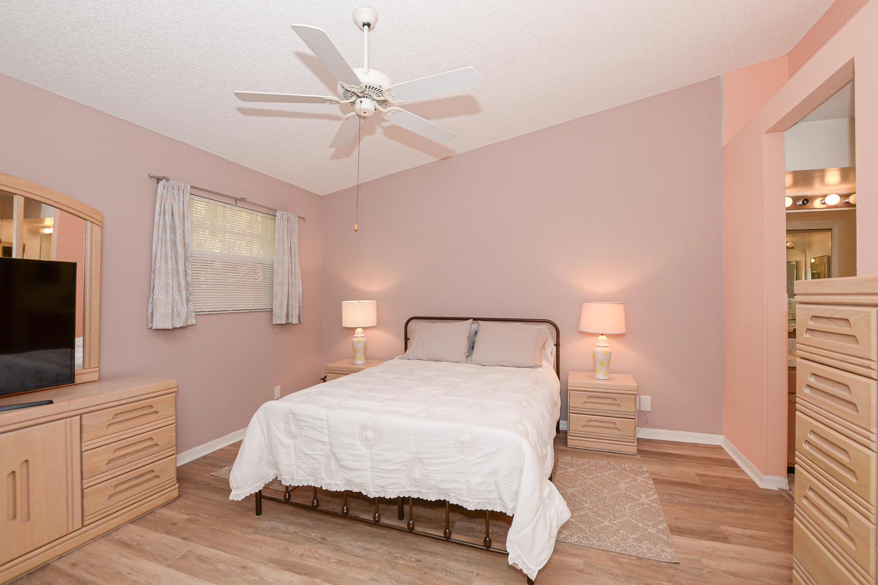 4064 Gator Trace Road Fort Pierce, FL 34982 - Photo 12 of 37 a bedroom with a bed and a flat screen tv