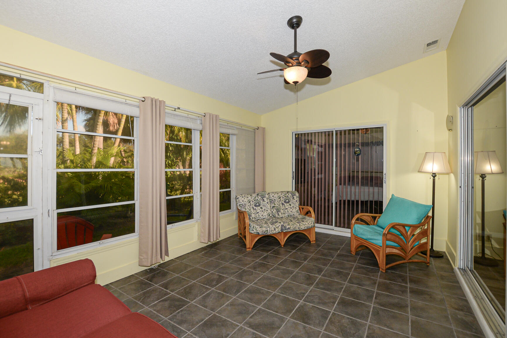 4064 Gator Trace Road Fort Pierce, FL 34982 - Photo 18 of 37 a living room with furniture and a floor to ceiling window