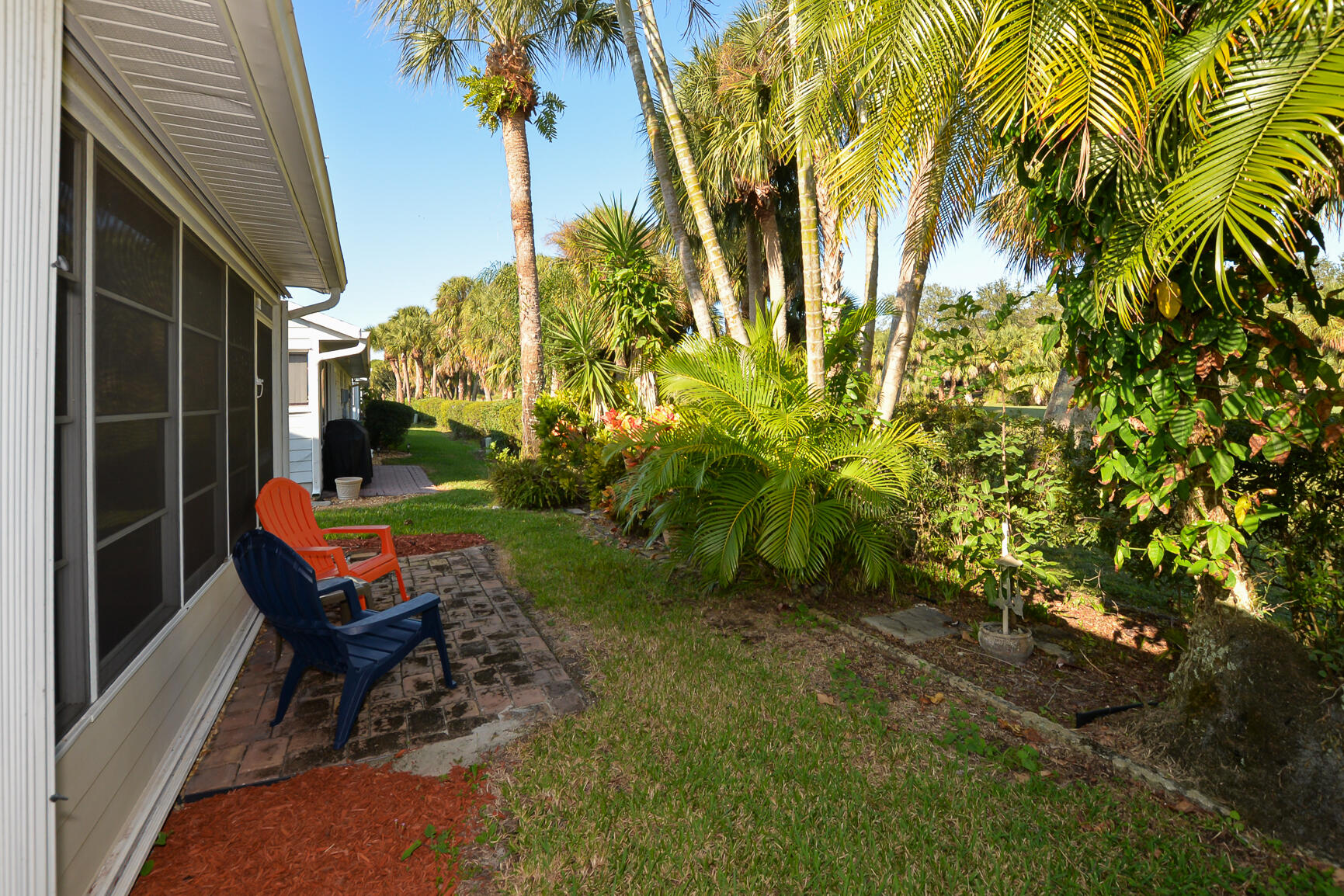 4064 Gator Trace Road Fort Pierce, FL 34982 - Photo 20 of 37 a backyard of a house with table and chairs