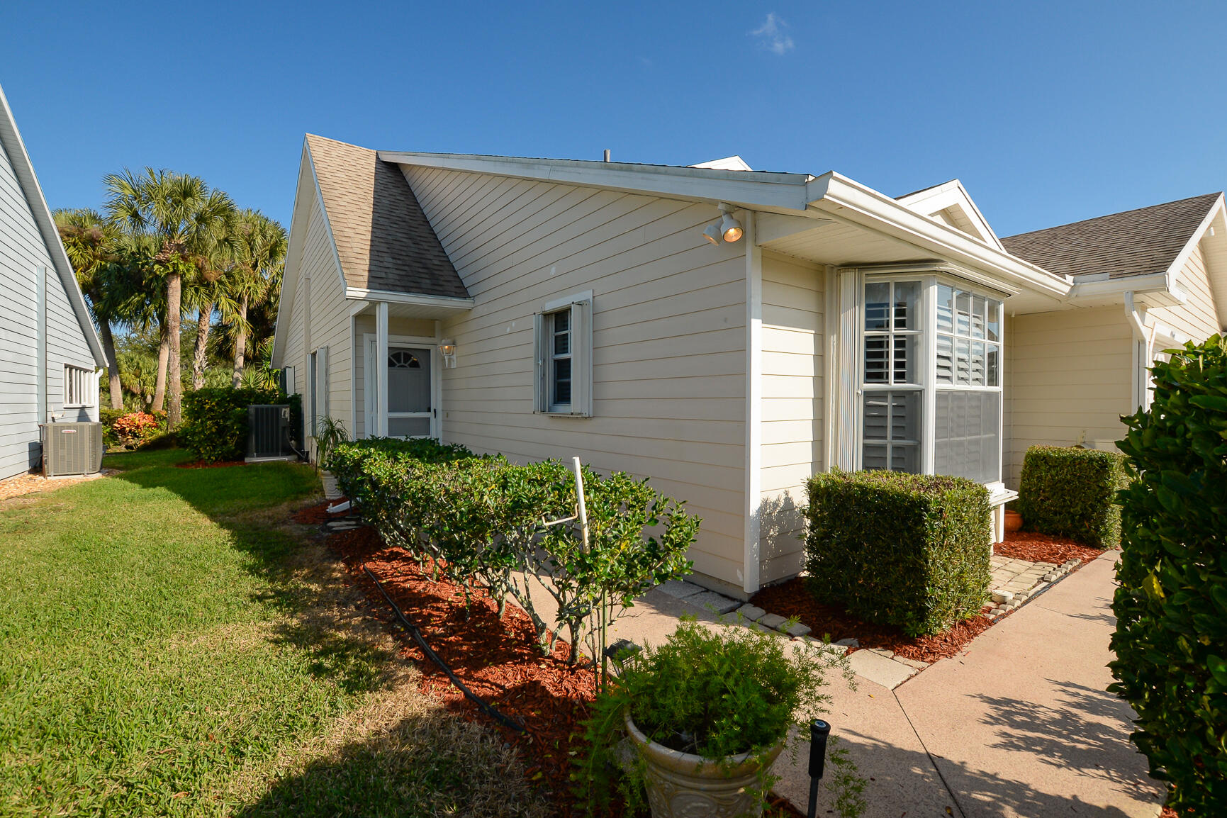 4064 Gator Trace Road Fort Pierce, FL 34982 - Photo 3 of 37 a front view of a house with garden