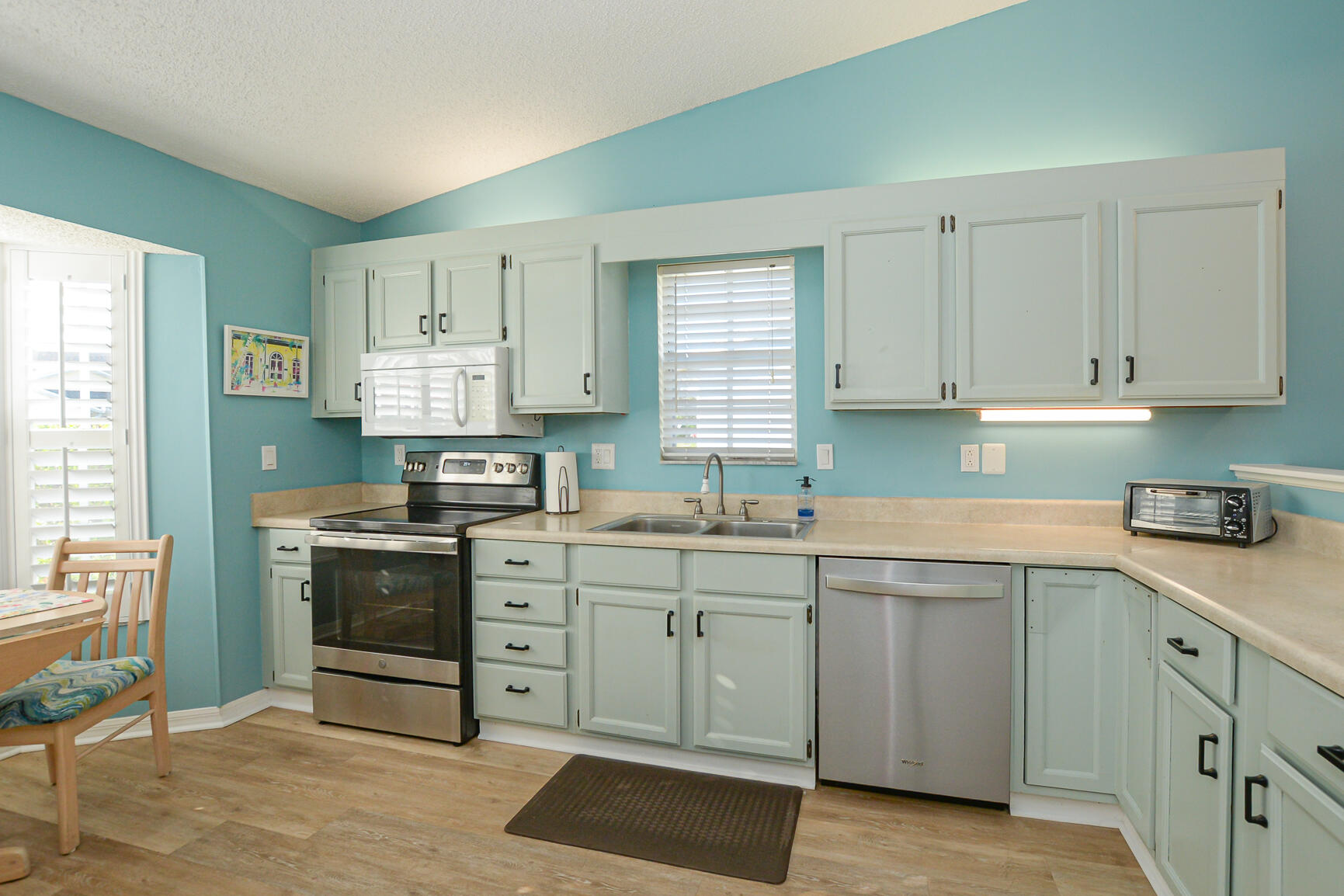 4064 Gator Trace Road Fort Pierce, FL 34982 - Photo 8 of 37 a kitchen with a stove sink and cabinets
