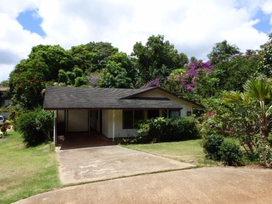 4971 Hekili Road Kapaa, HI 96746 - Photo 1 of 11 a front view of a house with a garden