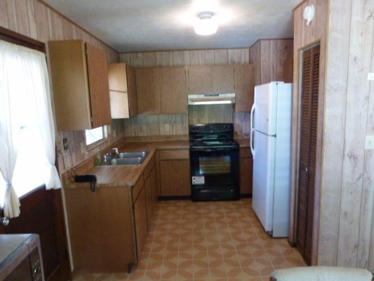 4971 Hekili Road Kapaa, HI 96746 - Photo 5 of 11 a kitchen with kitchen island granite countertop a refrigerator stove and sink