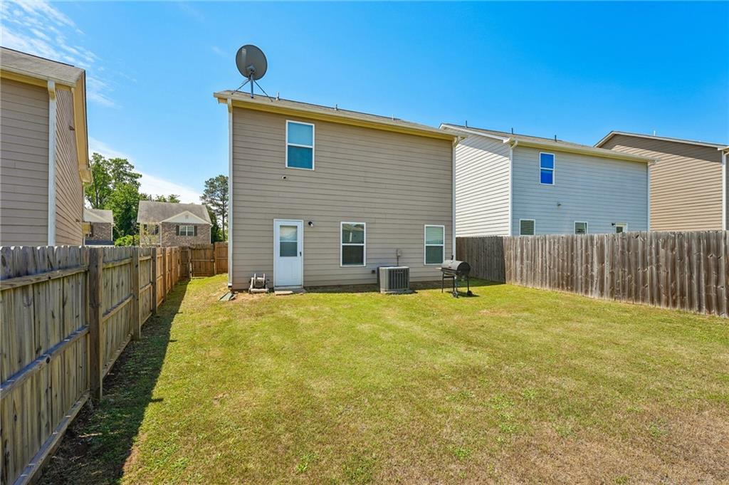 10933 Wheeler Trace Hampton, GA 30228 - Photo 22 of 22 a house view with a backyard space