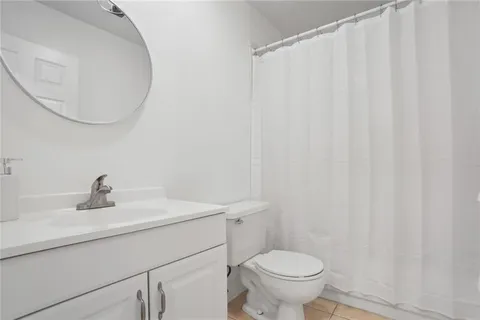 a bathroom with a sink a toilet and a mirror