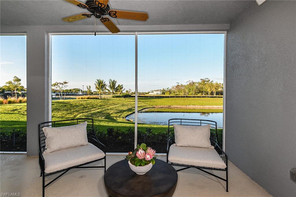 2665 Seychelles Circle, Unit 1902 Naples, FL 34112 - Photo 13 of 19 a view of a swimming pool and an outdoor seating