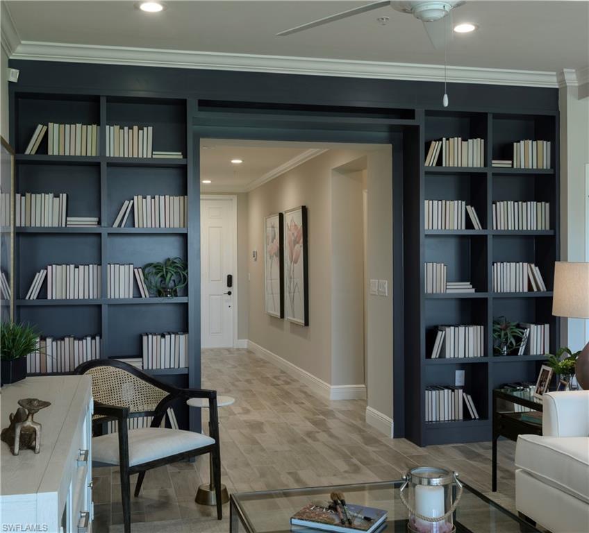 2665 Seychelles Circle, Unit 1902 Naples, FL 34112 - Photo 5 of 19 a view of a livingroom with bookshelf and furniture