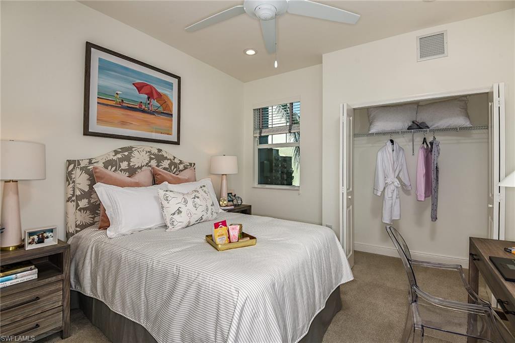 2665 Seychelles Circle, Unit 1902 Naples, FL 34112 - Photo 10 of 19 a bedroom with a bed and a painting on the wall