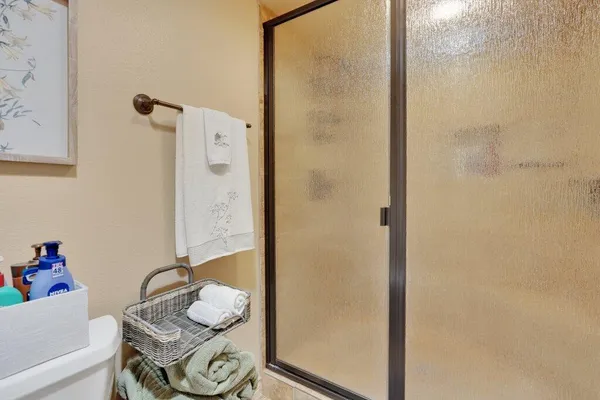 a bathroom with a granite countertop sink and a shower curtain