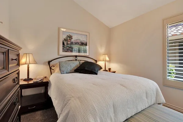 a bedroom with a large bed and a window