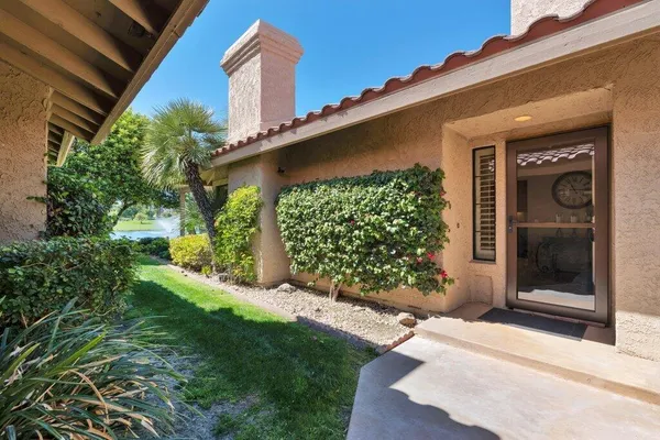a patio with garden area and outdoor seating