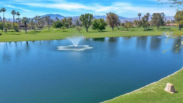 a front view of house with yard and outdoor seating