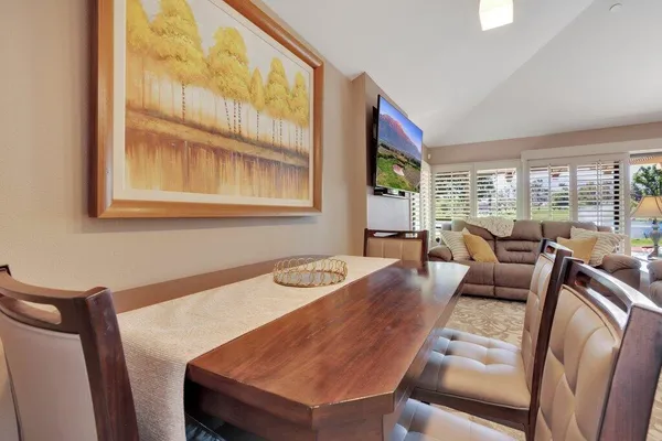 a dining room with furniture and a floor to ceiling window