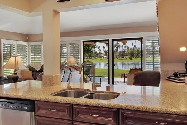 a kitchen with a sink a counter and cabinets