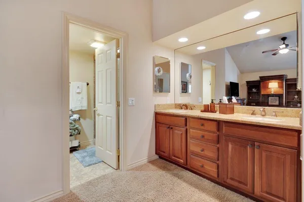 a spacious bathroom with a double vanity sink a mirror and shower