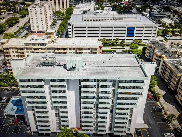 a view of a hallway with a fireplace and chandelier