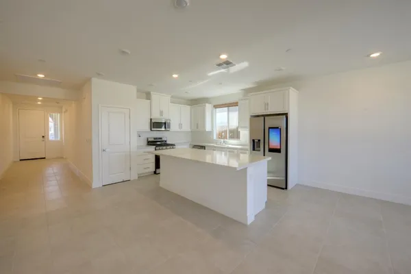 a kitchen with cabinets and refrigerator