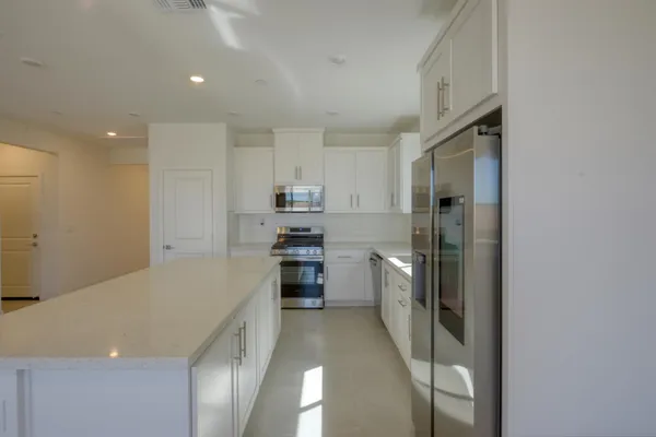 an empty room with windows and entrance