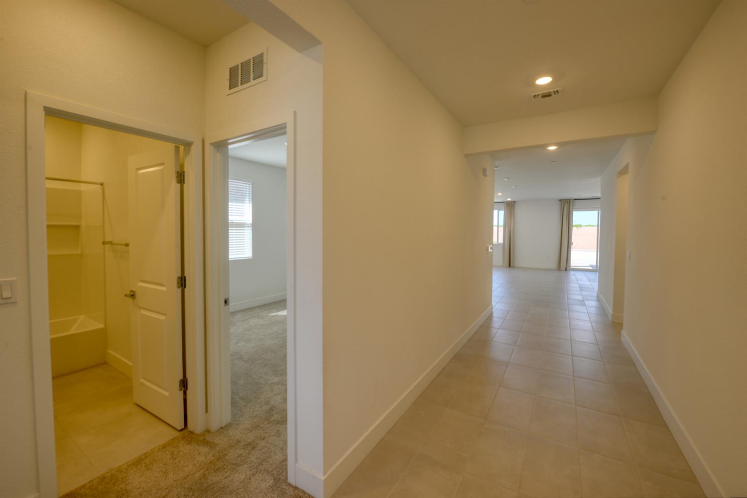 2109 Blossom Ranch Road Patterson, CA 95363 - Photo 4 of 33 a view of a hallway with wooden floor